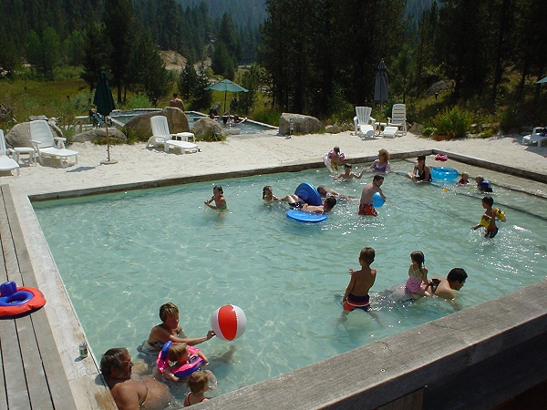 People Soaking in Sandy Bottomed Pool
